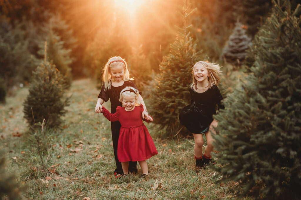Three sisters dancing at a Christmas Tree Farm around Harrisburg 