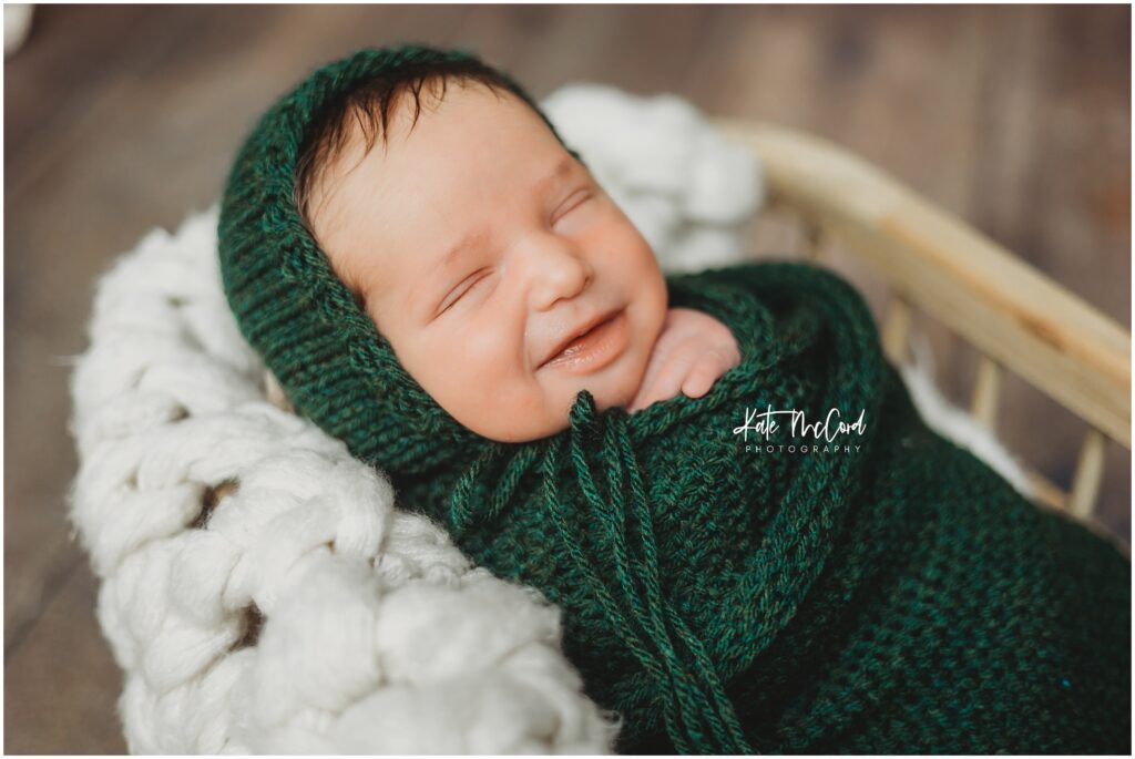 baby boy number five for mom and dad still brings the smiles in his newborn session