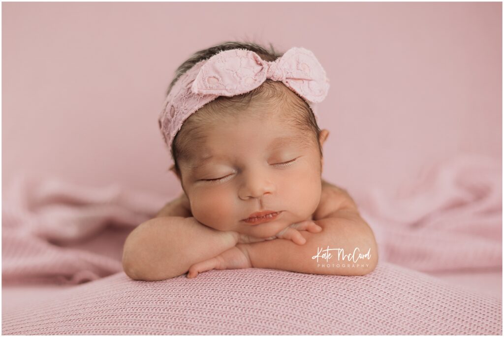 Baby girl sleeping on pink during her york newborn session