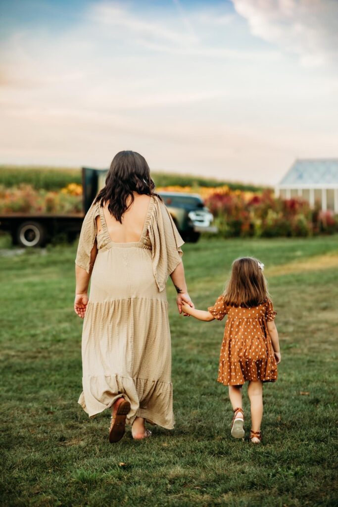 Mom and daughter holding hands during their family photoshoot
