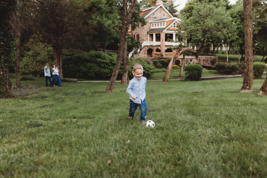 Young boy kicking a soccer ball ready for summer camp in Mechanicsburg