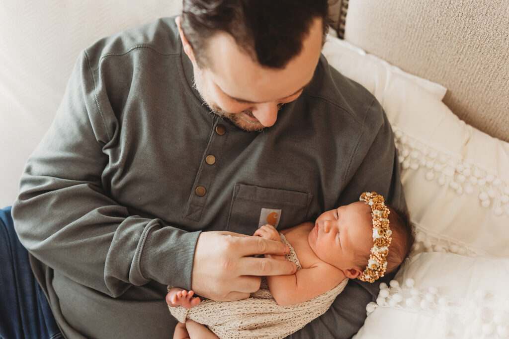 Dad loving on his newborn baby girl in a boho headband