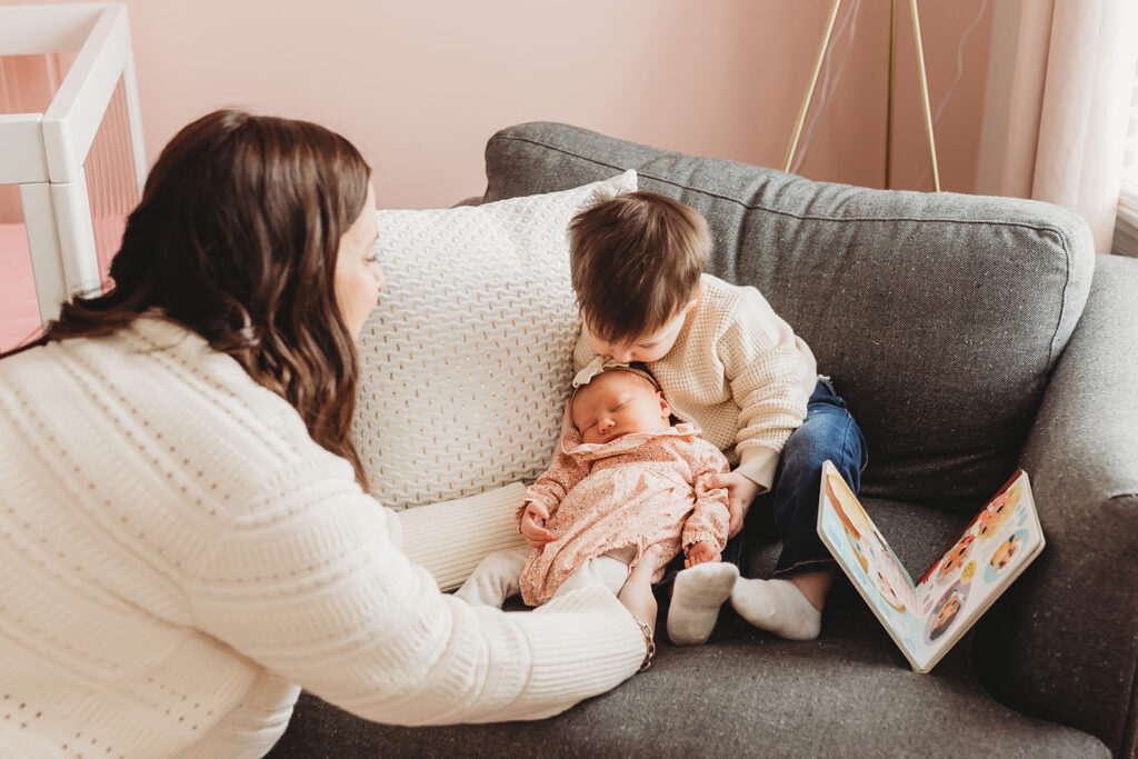 Big brother snuggling his baby sister during their in home york newborn session