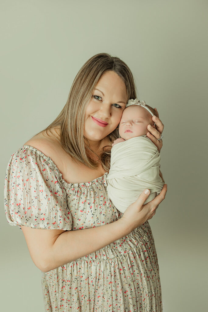 Mom wearing a studio provided dress during her mechanicsburg posed newborn session