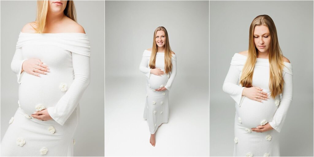 pregnant mother to be posing for studio maternity photos in a form fitting white dress with small flowers in her york maternity photography photos