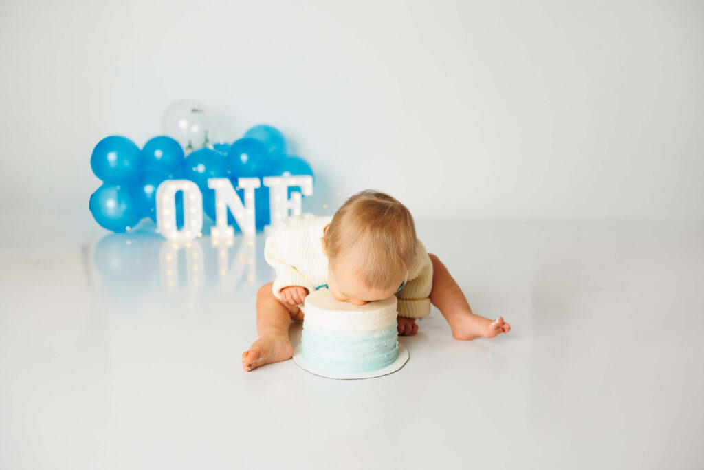 Baby boy going face first into his first birthday cake in York PA cake smash session