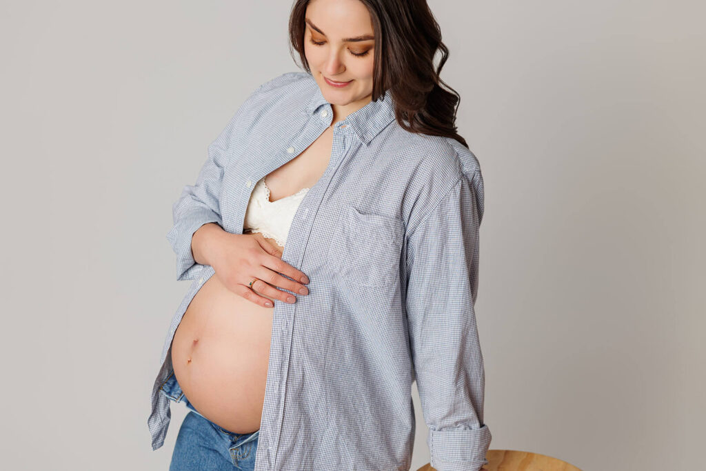 Pregnant mother holding her baby bump during pregnancy