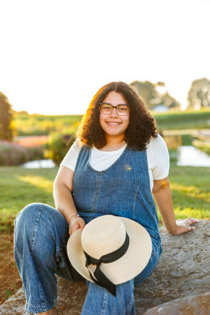 Class of 2027 senior sitting on a rock at Royal Oaks Farm during her Lebanon PA senior photography session