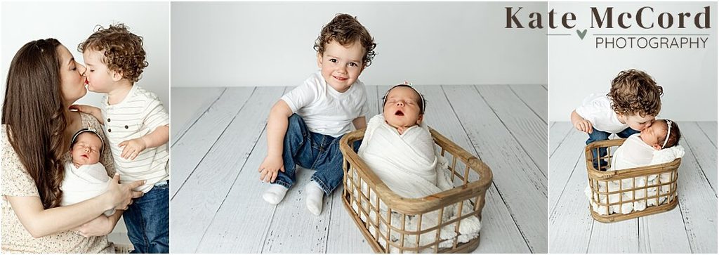 Mother and toddler son cuddling a newborn baby during soft, neutral studio sibling portraits.