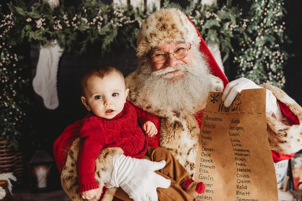 Baby posing with Santa Claus during a Christmas mini session in Central Pennsylvania